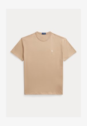 Beige cotton t-shirt with a crew neck, short sleeves, and a small white logo on the left chest. Smooth texture and casual fit.
