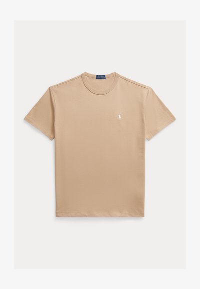 Beige cotton t-shirt with a crew neck, short sleeves, and a small white logo on the left chest. Smooth texture and casual fit.