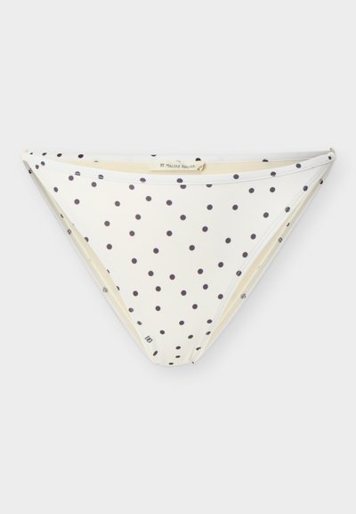 Λευκό κάτω μέρος μπικίνι με μαύρες πουά, χαμηλή μέση και μικρή ετικέτα στο μπροστινό αριστερό μέρος.