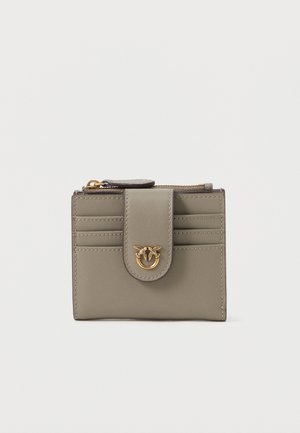 Olive green leather wallet with a snap closure, featuring gold hardware, multiple card slots, and a textured finish on the front.