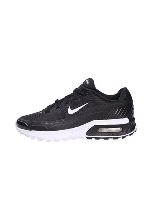 Chaussure de sport noire en mesh avec des accents blancs, présentant une semelle rembourrée, un bout rond et un détail de coussin d'air visible sur le côté.