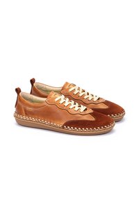 Zapatillas de cuero y ante marrones con cordones color crema, detalles de costura y una suela de goma flexible. Cuenta con un tirador en la parte posterior para facilitar el calzado.