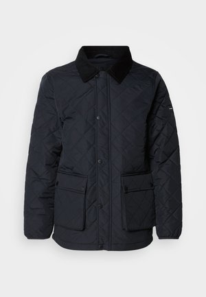 Giacca blu navy trapuntata con colletto in corduroy, due tasche frontali e chiusure a pressione. Presenta un tessuto testurizzato e resistente all'acqua.