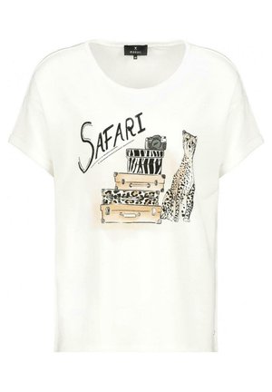 White short sleeve shirt with "SAFARI" text, stacked animal print suitcases, a camera, and a sitting cheetah illustration on front.