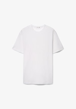 T-shirt bianca a maniche corte in tessuto strutturato con scollo rotondo. Etichetta della taglia visibile all'interno del colletto, orlo dritto sul fondo.