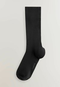 Sort sok lavet af glat stof, med en forstærket tå og ribbet kant, der viser et sømløst design og en afrundet tåform.