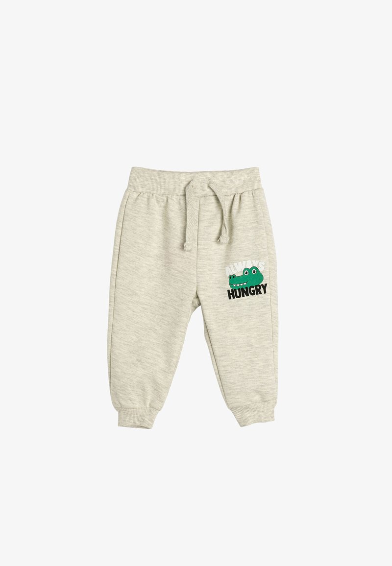 Lichtgrijze sweats met een elastische tailleband, voorzien van een trekkoord en een groene krokodilafbeelding met de tekst "Altijd Hongerig." Zachte textuur.