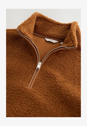Brun fleece-pullover med hög krage, halvdragkedja, texturerad utsida och slät foder, med silverfärgad dragkedja.