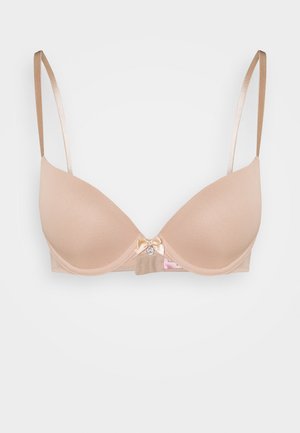 Beige voorgevormde beha van glad materiaal, met verstelbare satijnen schouderbanden en een decoratieve strik aan de voorkant boven een haak-en-oogsluiting.