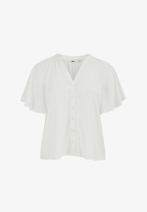 Balta trumpomis rankovėmis palaidinė su priekiniais mygtukais, V formos iškirpte ir laisvo, plazdančio audinio detalėmis ant rankovių ir pečių.