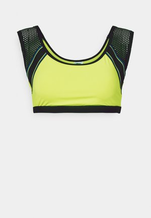 Neon yellow sports bra with black mesh accents, thick shoulder straps, and a black hem. Features smooth texture and structured design.