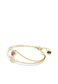 Gold bracelet featuring a heart-shaped pink stone, a clear square stone, and rhinestone accents along the band, with a clasp and chain extension.