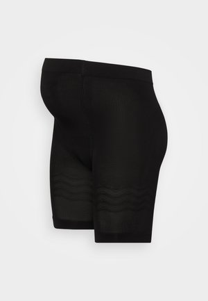 Zwarte compressiekorte broek met een gladde textuur, middellange pasvorm en subtiele zigzagpatronen aan de zoom. Naadloze constructie.