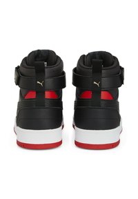 High-top sneakers in black leather with red accents, featuring dual straps, padded collar, and a white rubber sole with red detailing.