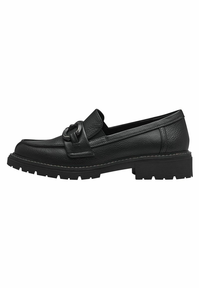 Black leather loafers with a wide strap and circular hardware detail. Textured upper, chunky rubber sole with tread design.