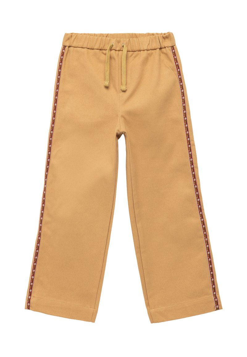 Tan katoenen broek met een elastische tailleband en een trekkoord. Rood-wit gestreept patroon aan de zijkant. Wijd uitlopende pasvorm.