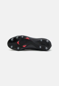 Black soccer cleat sole with round studs, red accents, and textured pattern. Features brand logo and "COPA" marking on the side.