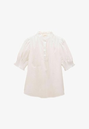 Biela bavlnená košeľa s vysokým výstrihom, nafúknutými rukávmi a naťahovanými manžetami. Obsahuje zapínanie na gombíky a voľný, pohodlný strih.