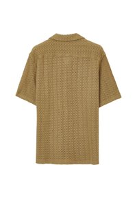 Maglietta a maniche corte in maglia beige, con vestibilità ampia e motivo aperto. Presenta un colletto classico e una texture traspirante.
