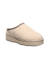 Cream-colored, fleece-lined slip-on slipper with a textured upper, a woven brown accent at the opening, and a light beige rubber sole.