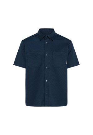 Kratka srajca z dolgimi rokavi temno modre barve, z dvema prsnikoma in klasičnim ovratnikom, oblikovana iz strukturirane tkanine.