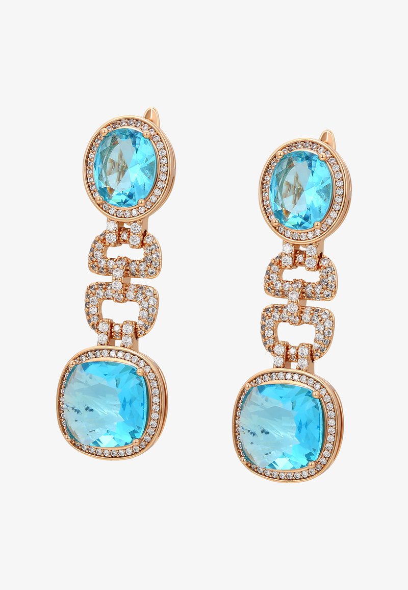 Zeltaini karstāks apakšējo auskari, kas satur divus lielus apaļus tirkīza akmeņus, ko ieskauj caurspīdīgi rhinestone akmeņi, savienoti ar savstarpēji savienotiem saitēm.