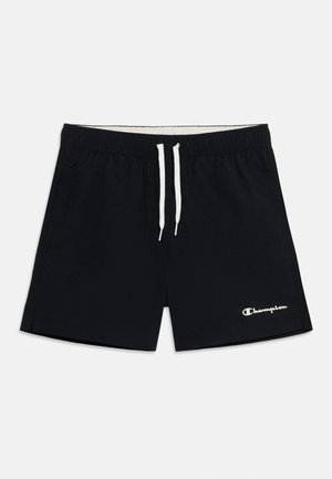 Short de sport noir avec un cordon blanc et le logo Champion sur la partie inférieure de la jambe droite, présenté à plat sur un fond clair.