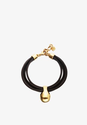 Bracelet multi-brins en cuir noir avec une fermeture, une chaîne et un pendentif abstrait en or au centre.