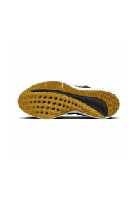 Shoe sole with yellow rubber tread and black traction patterns showcasing a white midsole and black accent running along the edge.