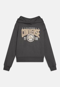 Felpa grigia con cappuccio caratterizzata da un grande logo beige "CONVERSE" e una grafica con il testo 1908 sul davanti, con polsini e orlo a coste.