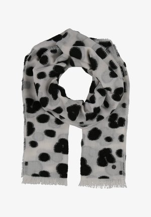 Écharpe gris clair avec des pois noirs irréguliers et des bords à franges, pliée en forme de boucle sur un fond blanc.