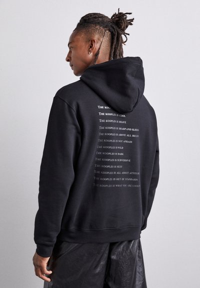 Black hooded sweatshirt featuring white text detailing on the back. Made of soft fabric with a relaxed fit and ribbed cuffs.