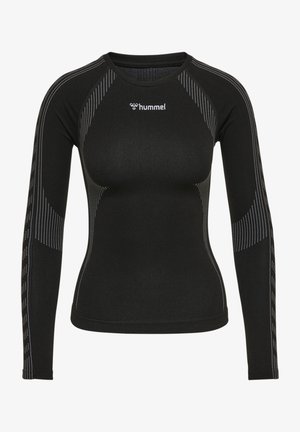 Czarna sportowa bluzka z długim rękawem z białymi wzorami w kropki i logo "hummel" na środku klatki piersiowej, dopasowany styl.