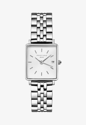 Reloj rectangular plateado con una esfera blanca texturizada, índices horarios aplicados, indicador de fecha y una pulsera de eslabones de metal pulido.