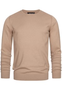 Beige ronde hals trui gemaakt van zachte gebreide stof, met lange mouwen en geribde boorden en onderrand voor een snug fit.