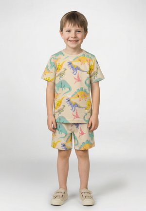 Beiges Set aus kurzärmligem T-Shirt und Shorts mit lebhaften Dinosaurier-Prints in Blau, Gelb, Pink und Grün. Der Stoff wirkt weich und angenehm.