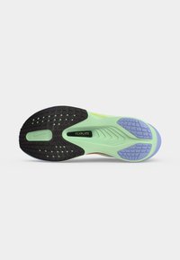 Εξωτερική σόλα παπουτσιού τρεξίματος Nike με μαύρες, ανοιχτοπράσινες και μοβ περιοχές πρόσφυσης, με ορατή πλάκα υποστήριξης "Flyplate".
