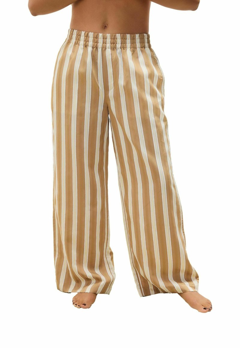Striped wide-leg pants in beige, cream, and white. Soft fabric with an elastic waistband. Flowy design with a relaxed fit, casual style.