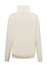 Cream-colored pullover with a high neck, long sleeves, and ribbed cuffs and hem. Made of smooth, soft fabric with no visible patterns.