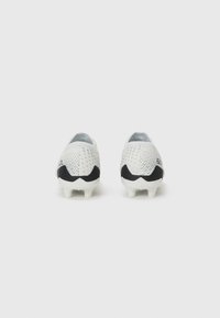 White football boots with a textured mesh upper, contrasting black accents at the heel, and white cleats for traction.