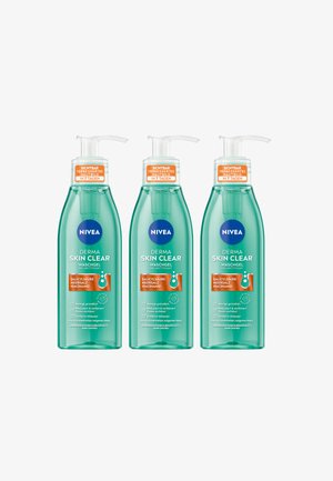 Three bottles of NIVEA Derma Skin Clear face wash gel, featuring a transparent green plastic body, pump top, and clear product labeling in orange and blue.