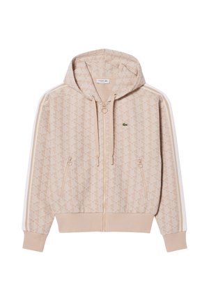 Felpa con zip beige con motivo geometrico, tasche laterali, cappuccio con cordino e strisce bianche sulle maniche con piccolo logo di coccodrillo verde sul petto.