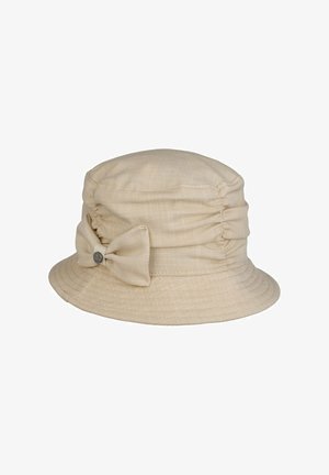 Beige fabric bucket hat with gathered sides and a matching fabric bow accented by a small round metal logo.