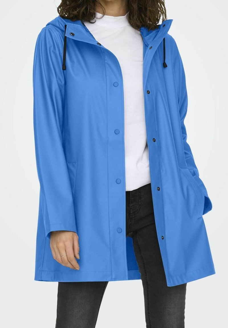 Light blue waterproof raincoat with a hood, snap buttons, and front pockets. Smooth texture and adjustable drawstring at the neckline.