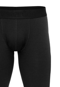 Black athletic leggings with a smooth texture, featuring a wide, branded waistband. Stitching is visible along the seams.