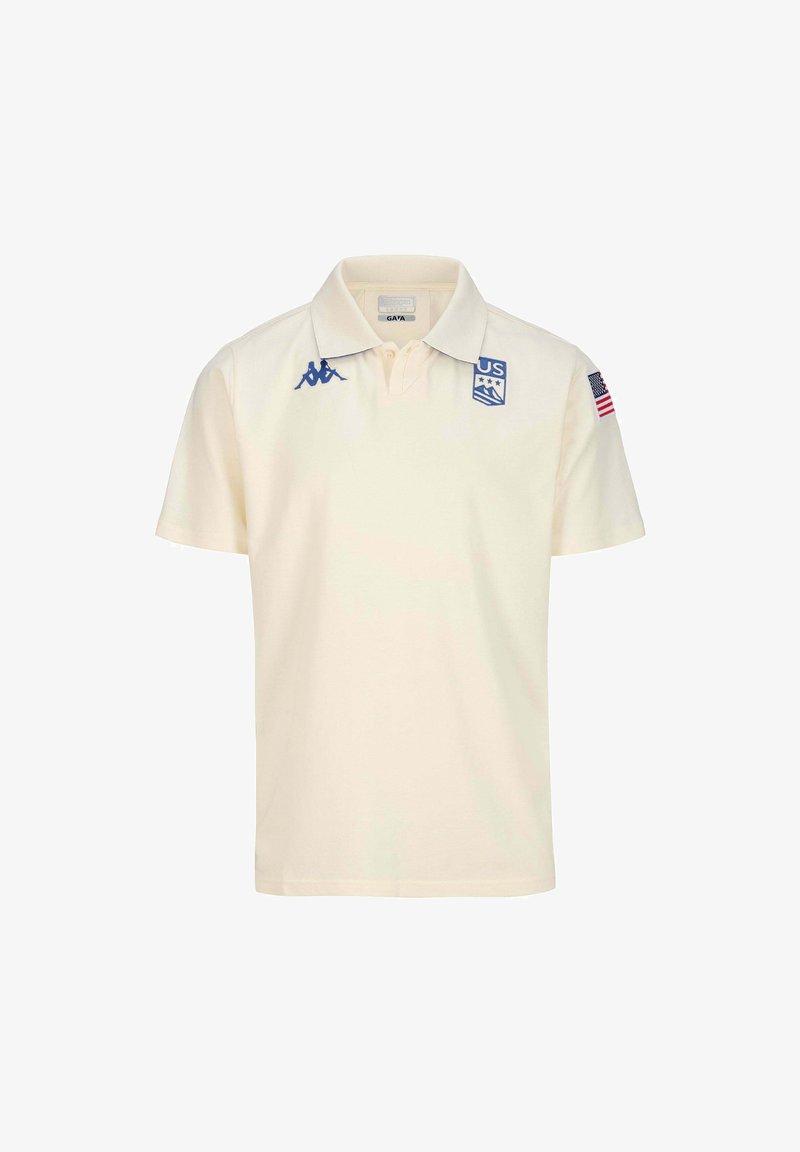 Polo shirt corto a maniche corte di colore crema realizzato in cotone. Presenta un logo blu, due stelle e un patch con la bandiera americana sulla manica sinistra. Colletto classico.