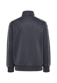 Donkergrijze sportjack met hoge kraag, ribbel manchetten en onderkant, en dunne witte strepen die langs de mouwen lopen.