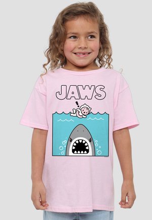 Pink cotton t-shirt featuring a graphic of a shark with an open mouth, bubbles, and a floating figure, labeled "JAWS" in bold letters.