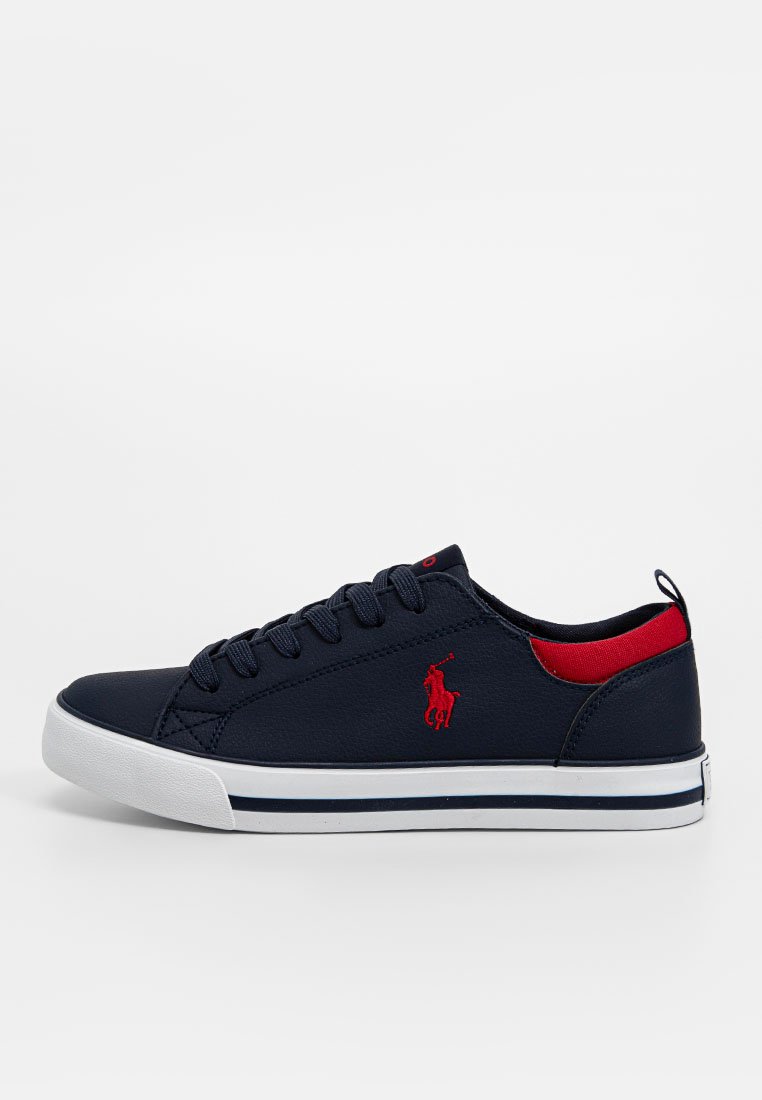 Marineblauwe canvas sneakers met rode accenten, vetersluiting, rubberen zool en witte strepen. Bevat geborduurd logo aan de zijkant.