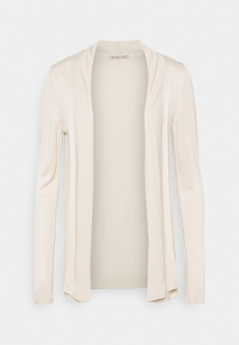 Cardigan crème à manches longues, ouvert sur le devant, coupe décontractée, tissu tricot léger avec de subtils détails de texture verticale le long des bords avant.